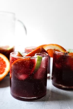 Red Wine Sangria Recipe with cinnamon, apples, oranges, brandy and triple sec.