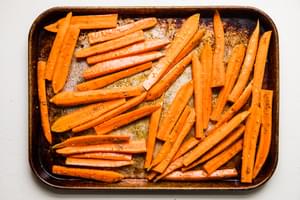 raw carrots tossed with salt, olive oil and za’atar on a baking sheet