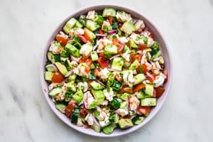 homemade ceviche in a bowl made with shrimp, limes, tomatoes, cucumbers, red onion, cilantro, cayenne, cumin and avocado.