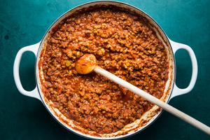 homemade simple ragù sauce in a pot with a wooden spoon
