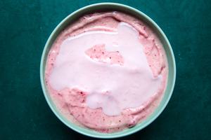 a smoothie bowl topped with coconut oil in a bowl sitting on the counter