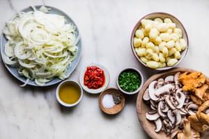 fennel bulbs, olive oil, mushrooms, gnocchi, salt, pepper, parsley and Calabrian chili peppers in bowls on the counter