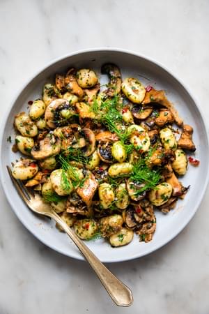 homemade Spicy Gnocchi with Fennel and Mushrooms in a bowl with a spoon