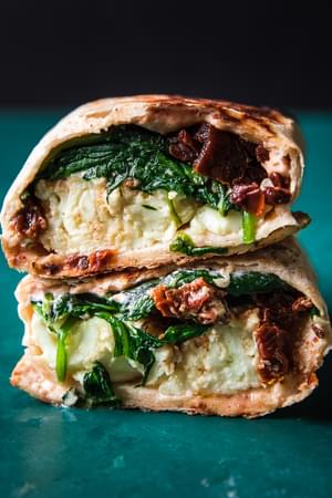 stacked spinach feta wraps filled with tomato cream cheese, sun dried tomatoes, feta & scrambled egg whites