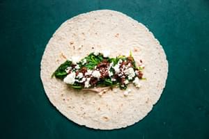 whole wheat tortilla with tomato cream cheese, cooked spinach, feta and sun dried tomatoes