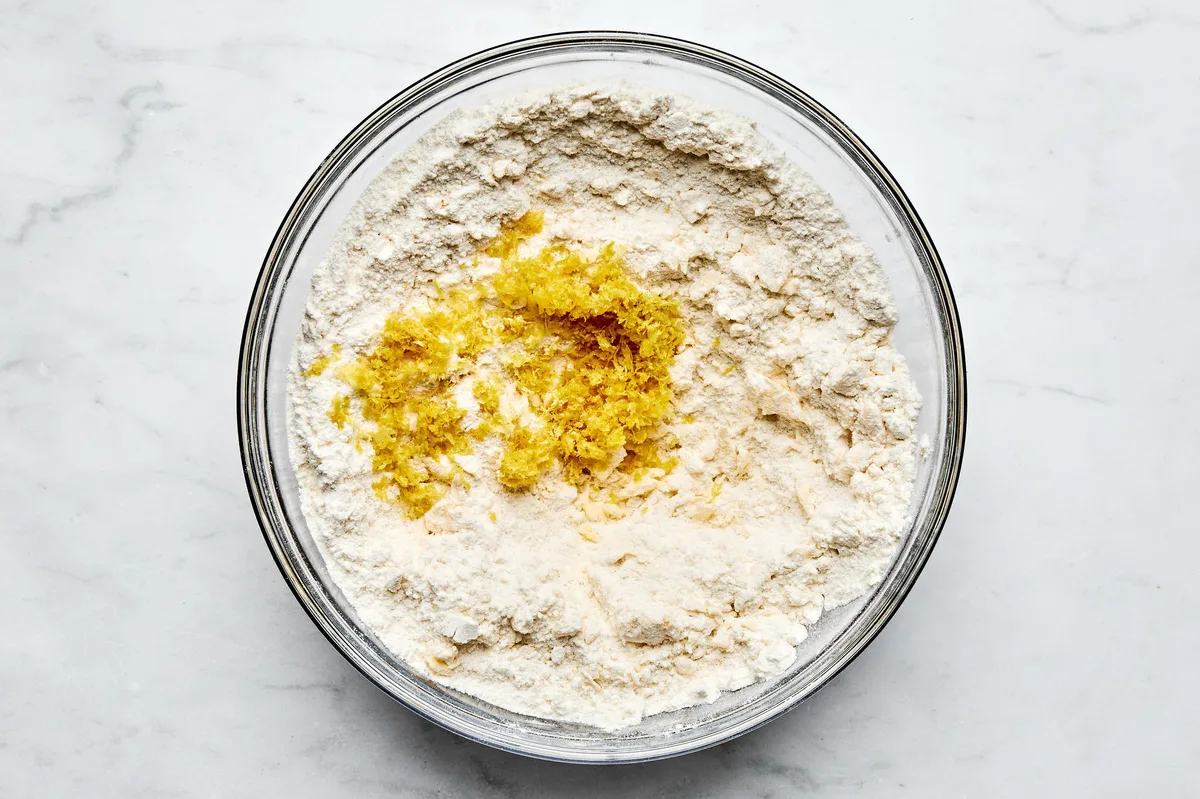 lemon zest added to a bowl of biscuit dough to use for shortcake