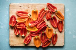 mini bell peppers on a cutting board