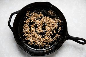 butter, shallot, garlic and chopped mushroom stems being cooked in a skillet