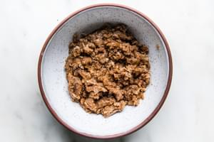 sweet potato casserole pecan streusel topping in a mixing bowl on the counter