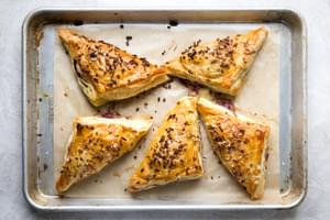 Baked puff pastry Turkey Hand Pies on a baking sheet