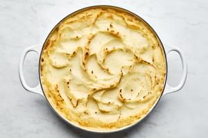 turkey shepherd's pie filled with turkey, onion, celery, carrots, green beans & topped with garlic mashed potatoes