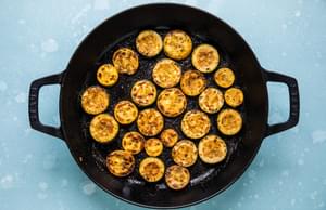 sliced zucchini and yellow squash seasoned with taco seasoning being fried in a skillet
