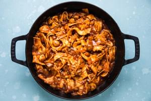 cooked vegetables, taco seasoning, green chilies, enchilada sauce and cut up corn tortillas stirred together in a skillet