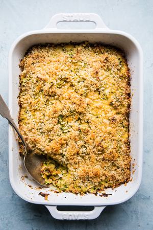 zucchini bake made with onions, dijon, garlic, parmesan, eggs, gruyere cheese, panko bread crumbs and butter