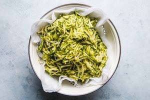 shredded zucchini in a colander