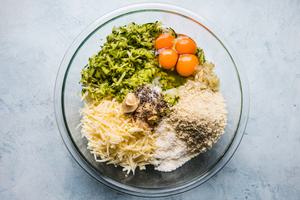 panko, eggs, zucchini, cheese and spices in a bowl for a zucchini bake