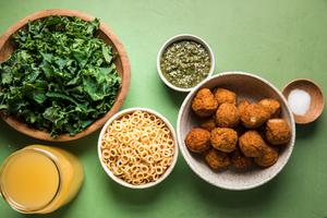 chicken meatballs, chicken stock, ditalini, kale, pesto and salt in bowls on the counter