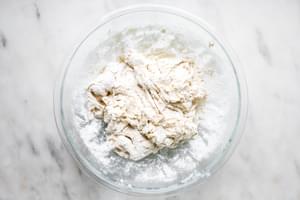 flour, salt, water and yeast mixed together in a bowl for homemade focaccia bread