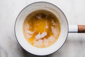 browned butter in a saucepan to drizzle on popcorn