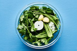 cilantro, lime juice, soy sauce, garlic, serrano pepper, water and salt in a food process to make the sauce for aguachile