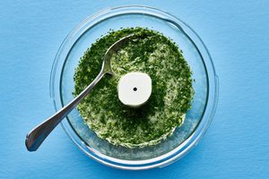 sauce for aguachile in a food process made with cilantro, lime juice, soy sauce, garlic, serrano pepper, water and salt