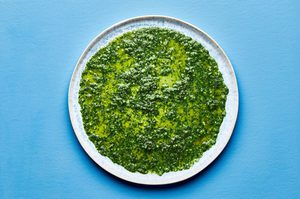 homemade vibrant green sauce for aguachile spread evenly on a serving platter