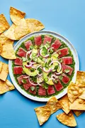 homemade aguachile on a serving platter surrounded by tortilla chips for serving