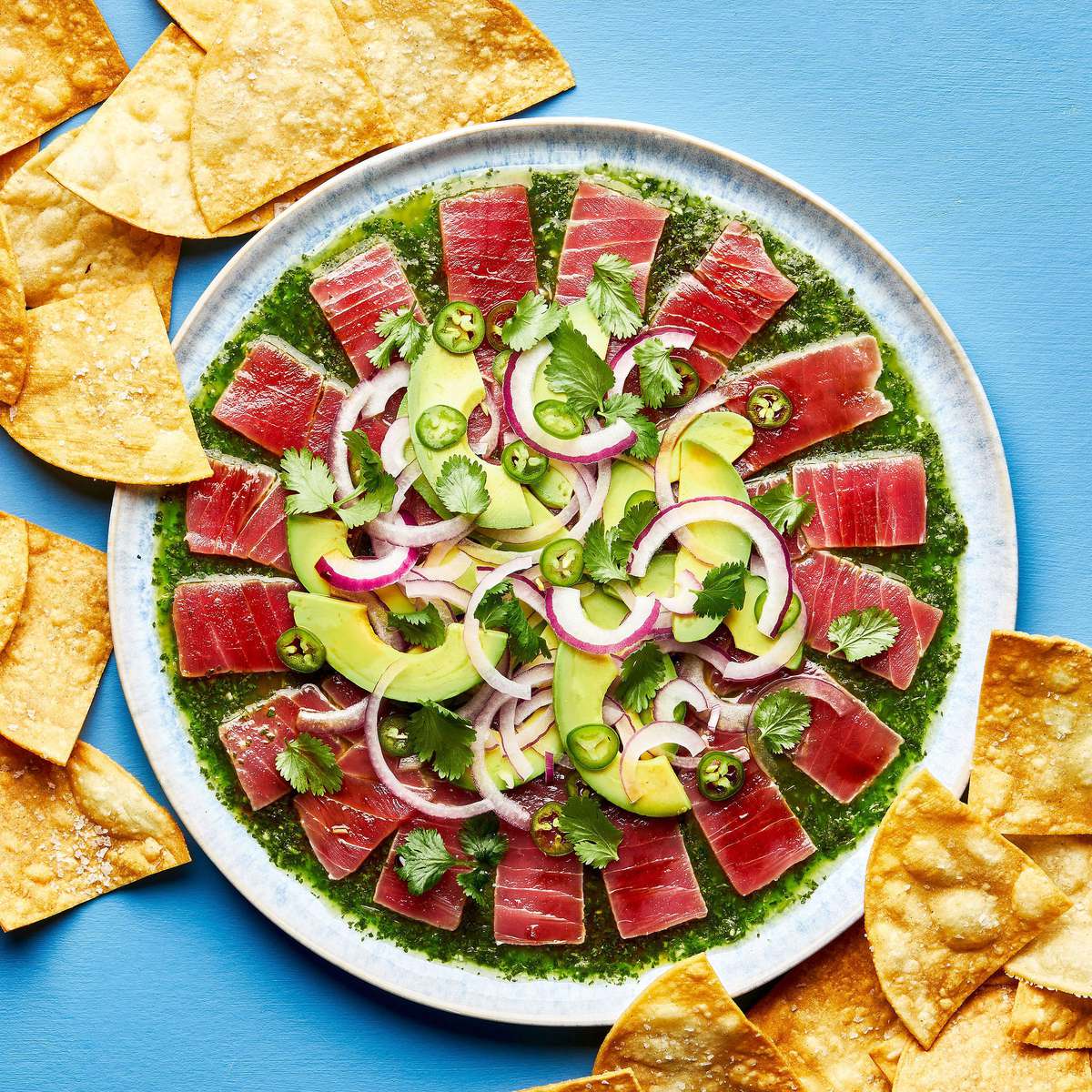 homemade aguachile on a serving platter surrounded by tortilla chips for serving