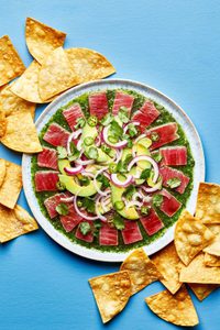 homemade aguachile on a serving platter surrounded by tortilla chips for serving