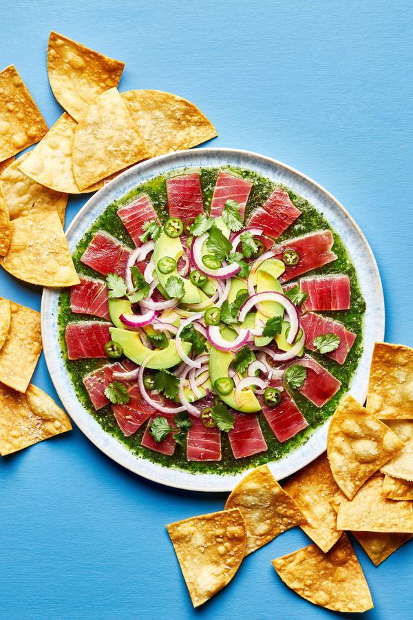 homemade aguachile on a serving platter surrounded by tortilla chips for serving