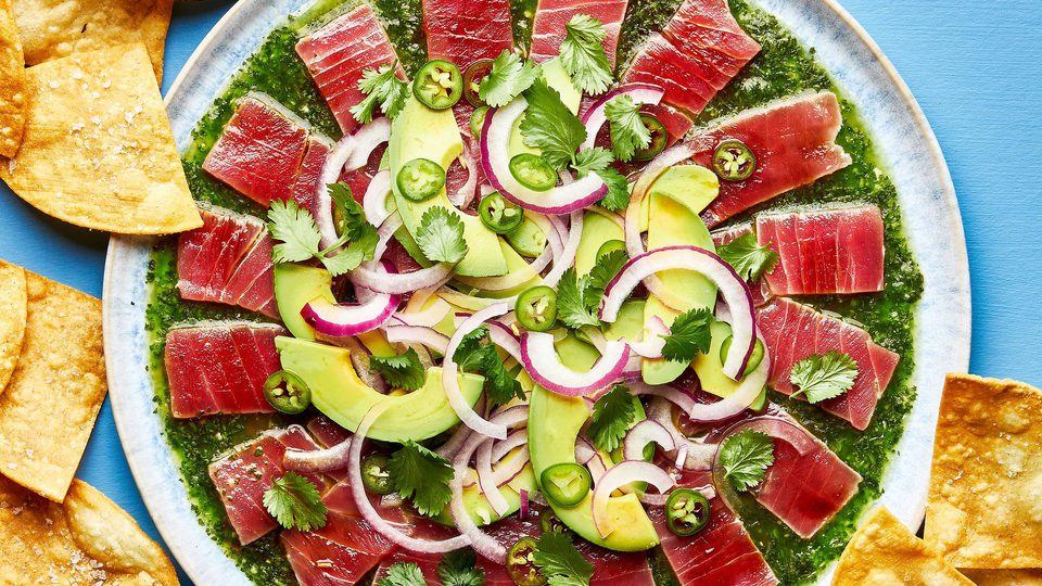 homemade aguachile on a serving platter surrounded by tortilla chips for serving