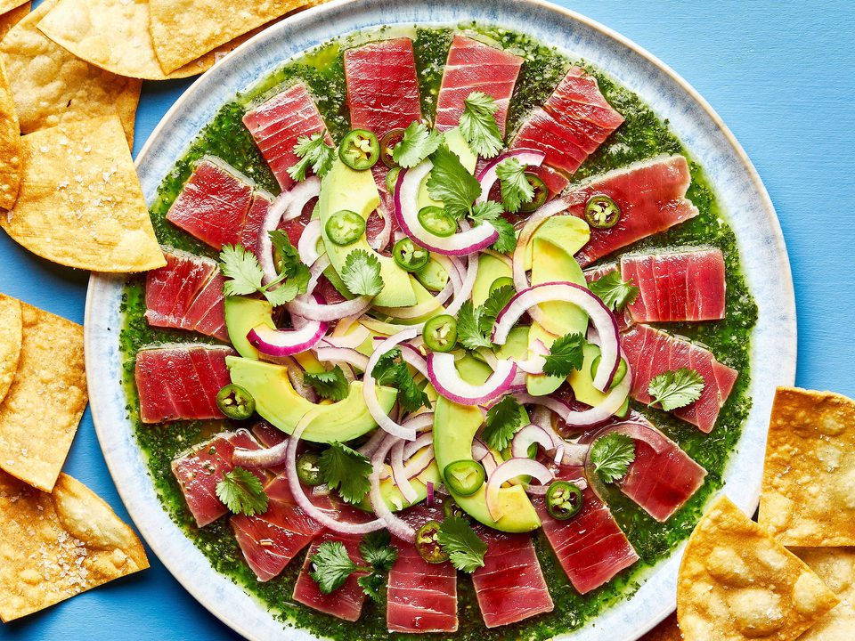 homemade aguachile on a serving platter surrounded by tortilla chips for serving