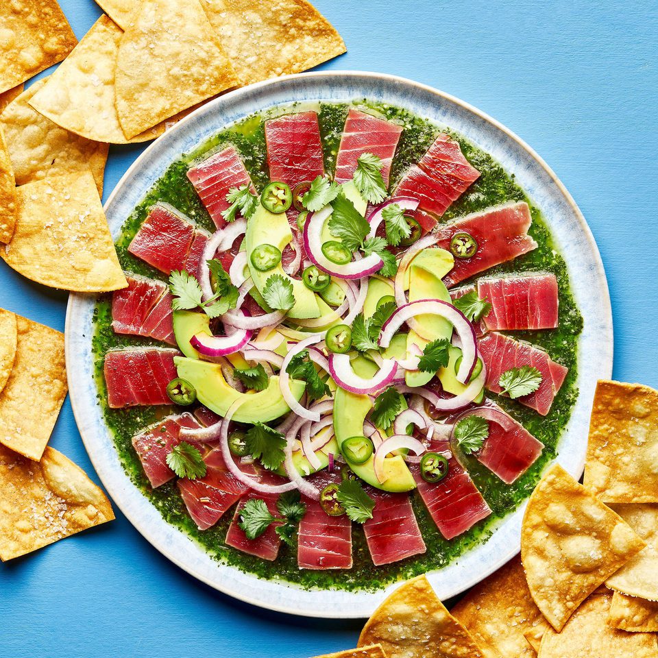 homemade aguachile on a serving platter surrounded by tortilla chips for serving