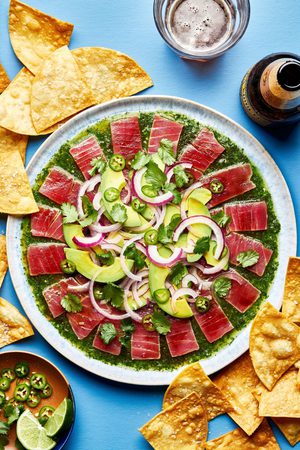 homemade aguachile on a serving platter surrounded by tortilla chips for serving