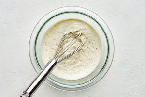 a bowl of homemade creamy parmesan lemon dressing made with lemon juice, olive oil, parmesan, mayo, dijon and spices