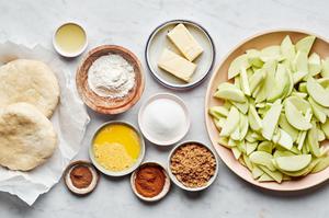 apples, pie crusts, butter, flour, sugar, brown sugar, cinnamon, nutmeg, lemon juice and egg to make homemade apple pie