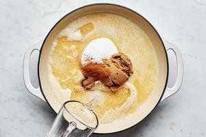 water being poured into a pot with melted butter, flour, sugar, brown sugar, cinnamon, nutmeg and lemon juice for apple pie