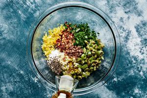 parsley, olives, anchovy, garlic, lemon zest & juice, salt, red pepper flakes, pepper & olive oil in a bowl for tapenade