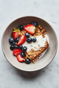 a slice of baked oatmeal seasoned with maple, cinnamon & nutmeg drizzled with milk and topped with fresh berries