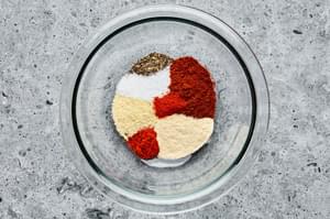 salt, garlic powder, onion powder, pepper, chili powder, paprika and cayenne in a bowl for dry rub to put on pork ribs