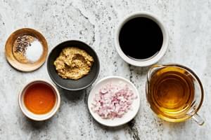 mustard, honey, balsamic vinegar, olive oil, shallot, salt, and pepper in bowls to make homemade balsamic vinaigrette