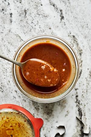 balsamic vinaigrette in a bowl with a spoon made with mustard, honey, balsamic vinegar, olive oil, shallot, salt & pepper