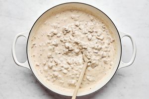a pan of creamy homemade sausage gravy ready to be used on top of tender golden biscuits