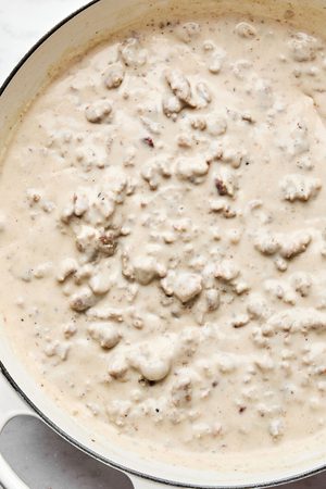 a pan of creamy homemade sausage gravy ready to be used on top of tender golden biscuits