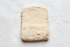 homemade biscuit dough being rolled old to make biscuits and gravy for a cozy, hearty breakfast