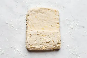 homemade biscuit dough being rolled old to make biscuits and gravy for a cozy, hearty breakfast