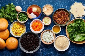 bowls of black beans, corn, jalapeno, carrots, onion, spices, chipotle mayo, pepper jack and buns to make black bean burgers