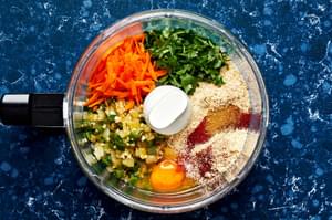 carrots, cilantro, cumin, onion, salt, paprika, chili powder, egg, breadcrumbs, cooked onion & jalapeños in a food processor