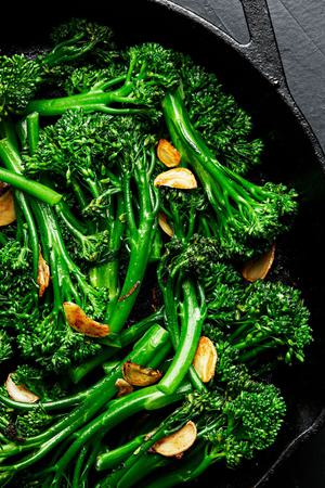 a frying pan full of broccolini cooked in olive oil and butter with salt and garlic and sprinkled with flaky salt