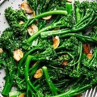 a plate of homemade broccolini cooked in olive oil and butter with salt and garlic and sprinkled with flaky salt